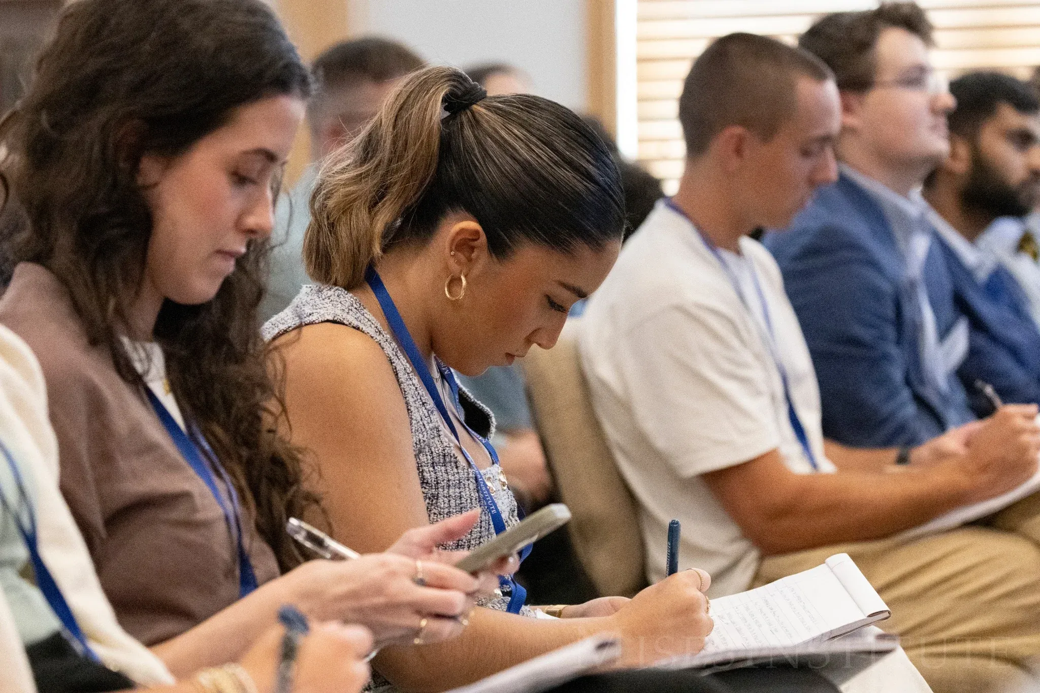 Students writing notes during a lecture