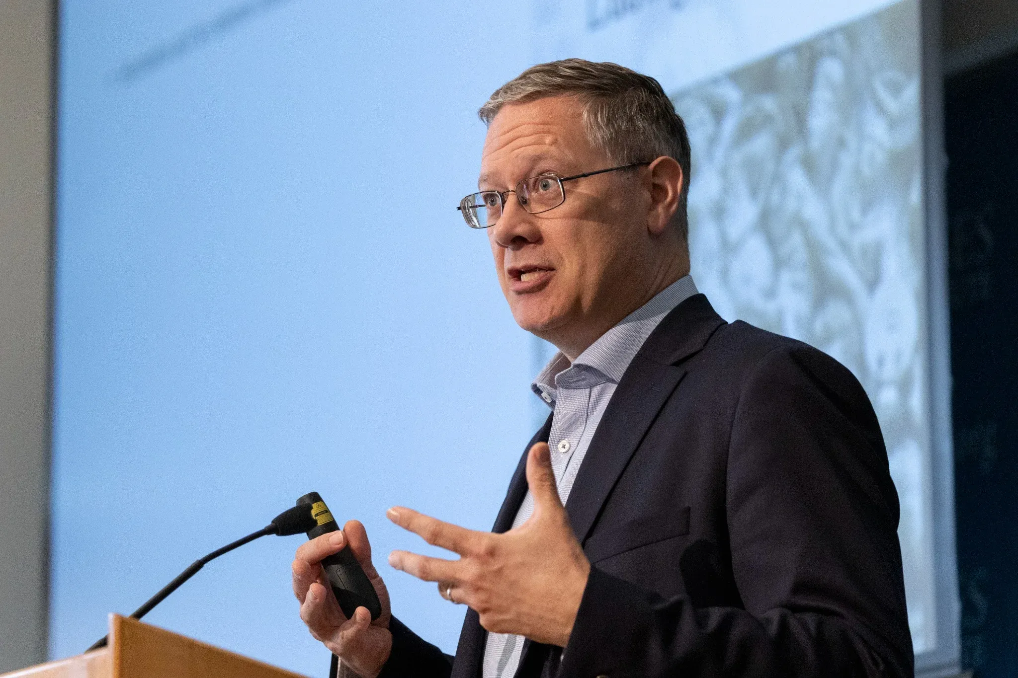 A scholar explaining an idea during a lecture