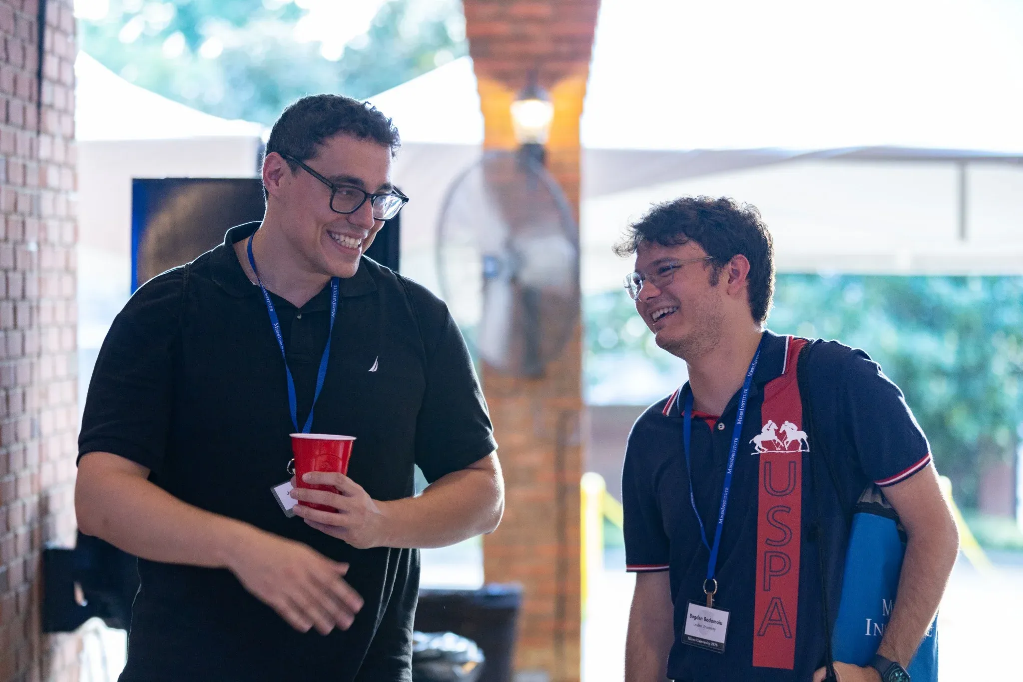 Two students laughing outside
