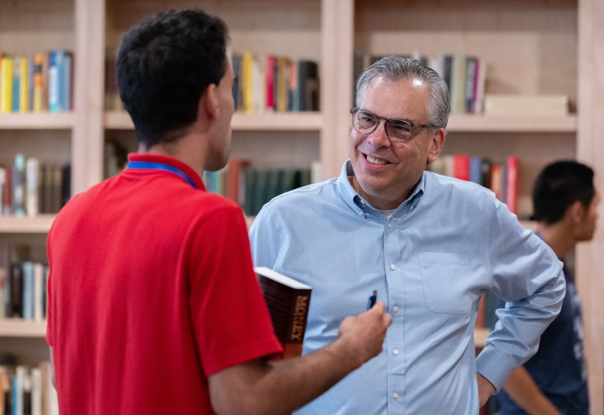 A student speaking with a scholar